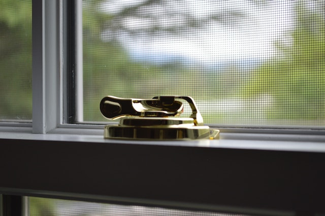 close up of a golden window latch