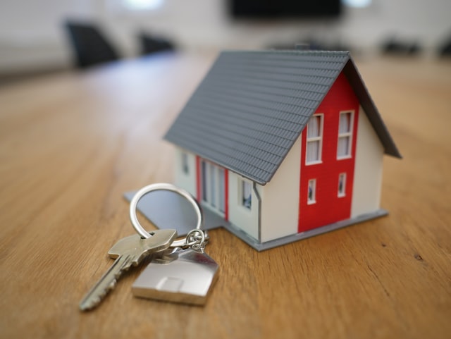 house figurine with a red door and a set of keys