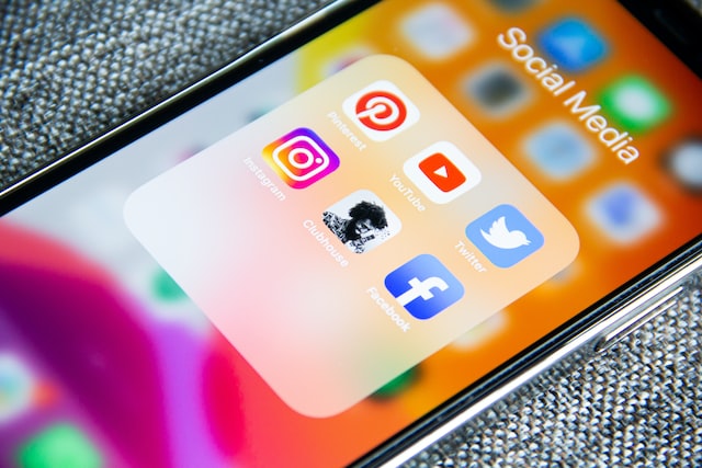 iPhone with social media apps organized in one folder