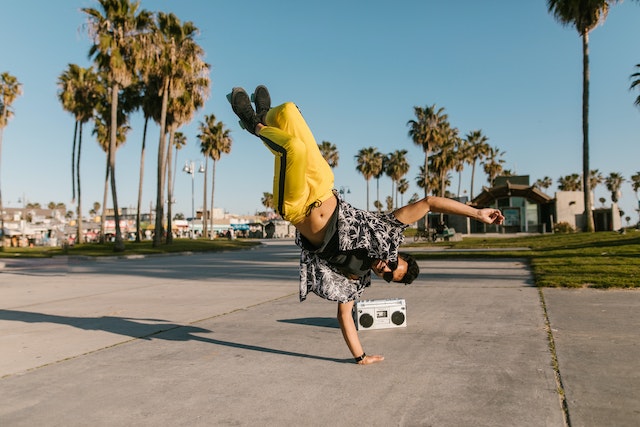 person break dancing with palm trees in the background